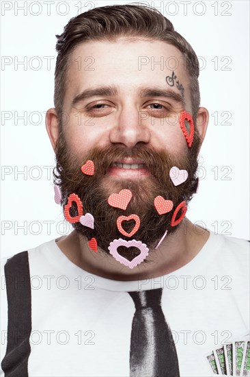 Funny bearded man with hearts Valentine's Day. Portrait shot in studio