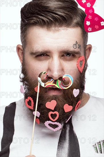 Funny bearded man with hearts Valentine's Day. Portrait shot in studio