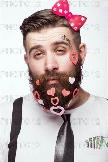 Funny bearded man with hearts Valentine's Day. Portrait shot in studio