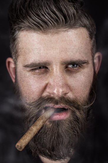 A solid man with a beard and mustache. Photos shot in the studio