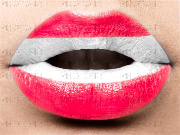 Female lips close up with a picture of the flag of Austria. white