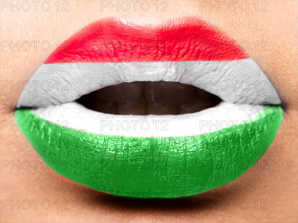 Female lips close up with a picture of the flag of Hungary. White