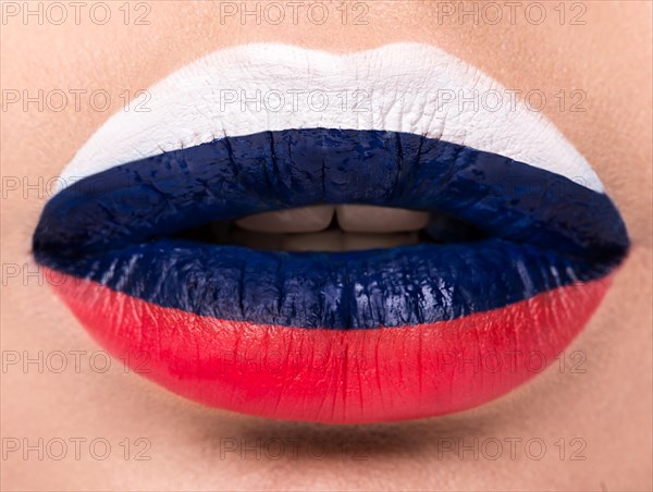 Female lips close up with a picture of the flag of Germany. black