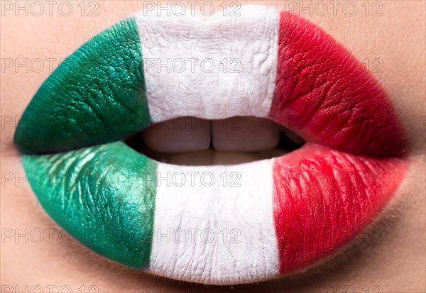 Female lips close up with a picture flag of Italy. Green