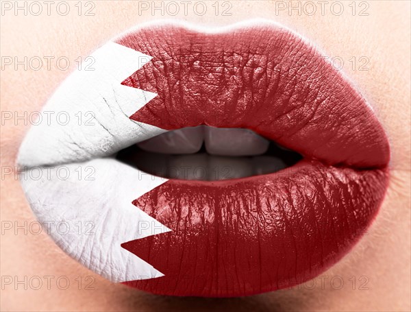 Female lips close up with a picture of the flag of Katar. Red and white