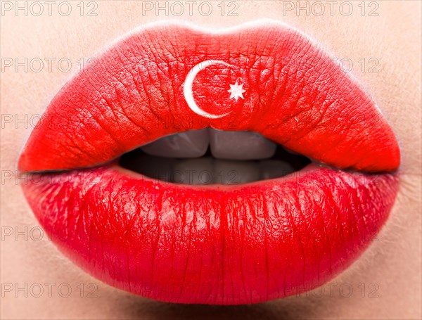 Female lips close up with a picture of the flag of Turkey. Red and white month