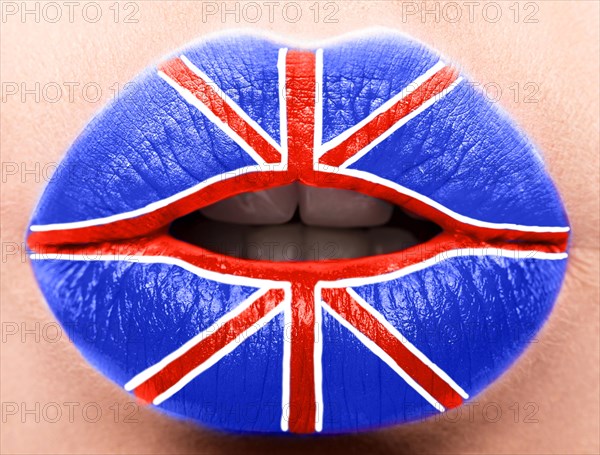 Female lips close up with a picture of the flag of United Kingdom. Blue