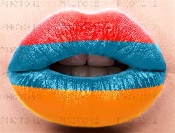 Female lips close up with a picture of the flag of Armenia. Blue