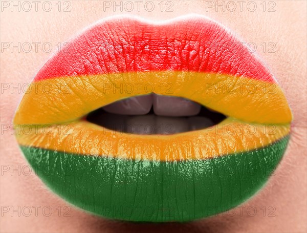 Female lips close up with a picture of the flag of Bolivia. Yellow
