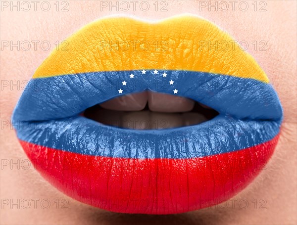 Female lips close up with a picture of the flag of Venesuela. Blue