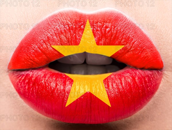 Female lips close up with a picture of the flag of Vietnam. Red