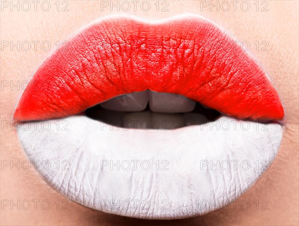 Female lips close up with a picture of the flag of Indonesia. white