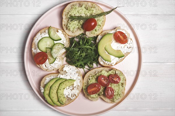 Vegan sandwiches with curd cheese and vegetables on wooden background