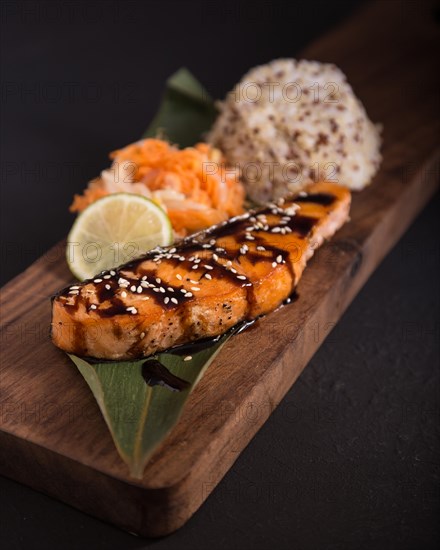 Teriyaki salmon with rice on a wooden platter. Top view. Photo shot in studio