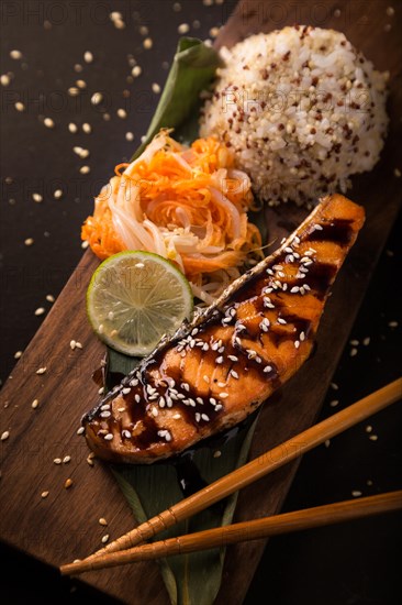 Teriyaki salmon with rice on a wooden platter. Top view. Photo shot in studio