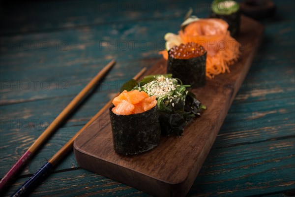 Sushi set on a wooden tray. Photo shot in studio