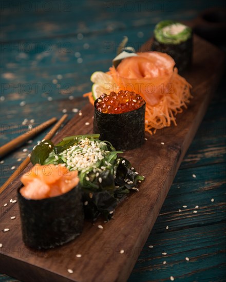 Sushi set on a wooden tray. Photo shot in studio