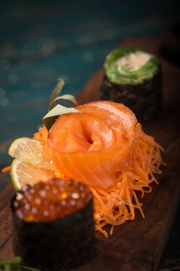 Sushi set on a wooden tray. Photo shot in studio