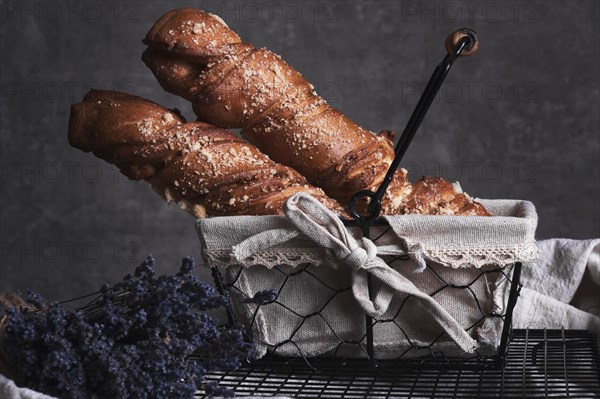 White bread in a basket and lavender flowers in vintage style