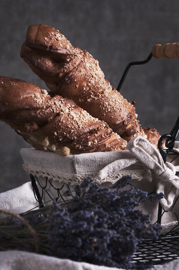 White bread in a basket and lavender flowers in vintage style