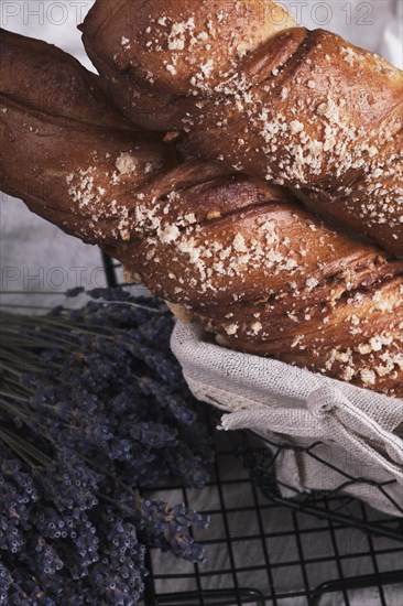 White bread in a basket and lavender flowers in vintage style