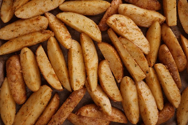 Roasted potatoes in the oven with spices and herbs