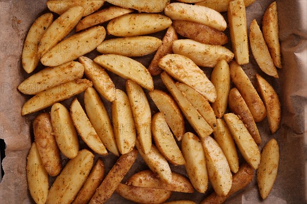 Roasted potatoes in the oven with spices and herbs