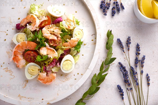 Vegetable salad with quail egg and shrimps