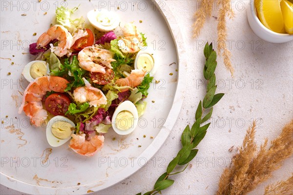 Vegetable salad with quail egg and shrimps