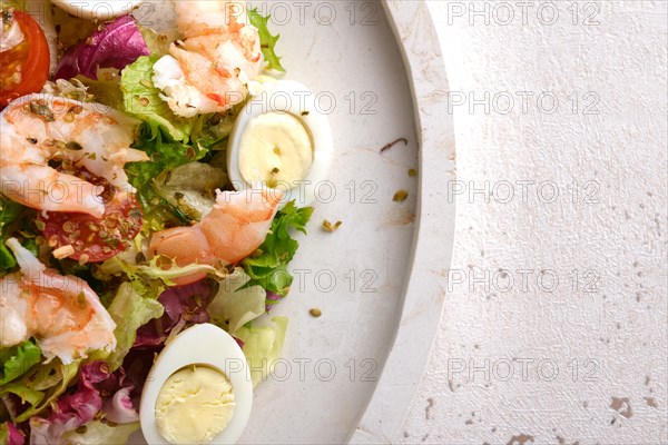 Vegetable salad with quail egg and shrimps