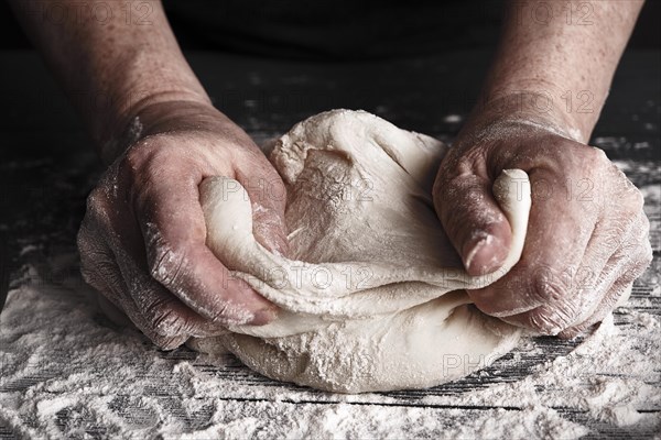 Cooking dough by elderly woman cook hands for homemade pastry bread