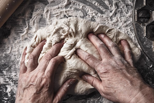 Cooking dough by elderly woman cook hands for homemade pastry bread