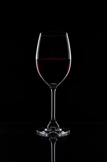 Red wine in a glass isolated on black background