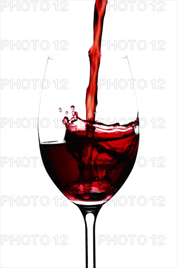 Red wine in a glass isolated on white background