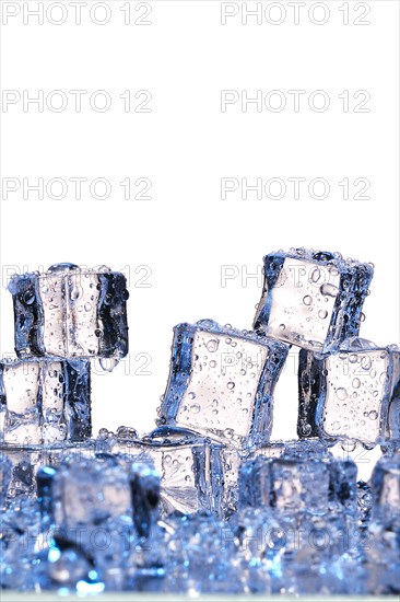 Transparent cold ice cubes on a white background