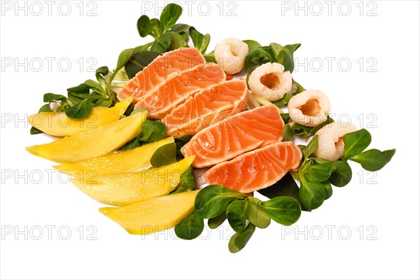 Assorted raw salmon with greens and mango isolate on a white plate. Japanese restaurant menu