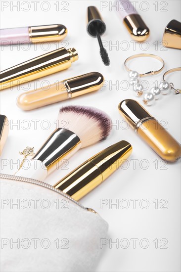 Set of brushes and cosmetic products in a cosmetic bag on a white background