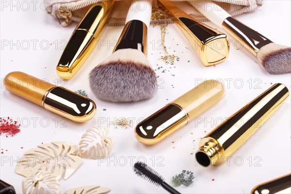 Set of brushes and cosmetic products in a cosmetic bag on a white background