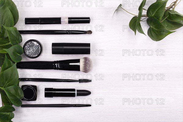 Set of brushes and cosmetic products in a cosmetic bag on a white background