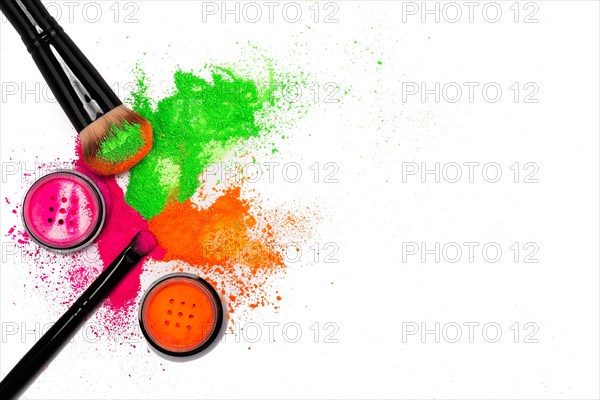 Cheek brush with neon cosmetic powder colorful pile and isolated on white background