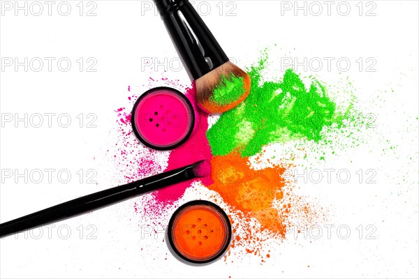 Cheek brush with neon cosmetic powder colorful pile and isolated on white background