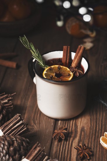 Christmas hot drink mulled wine on wooden background with cinnamon