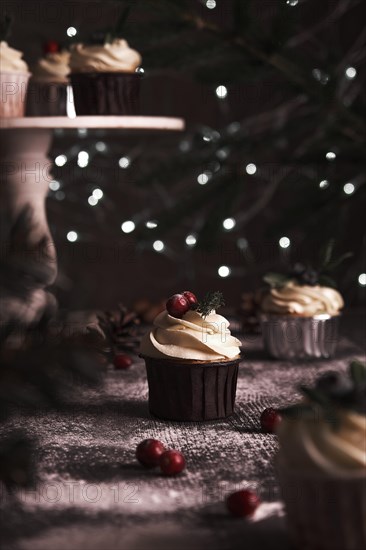 Christmas cakes on wooden background with new year garlands