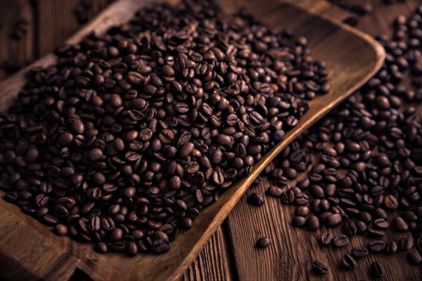 Roasted coffee beans close-up on a wooden surface