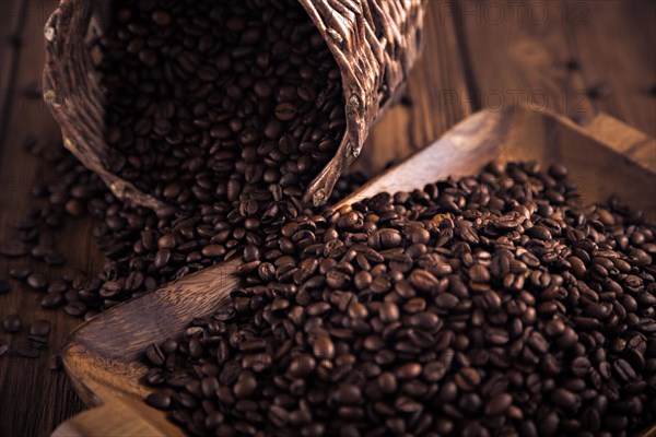 Roasted coffee beans close-up on a wooden surface