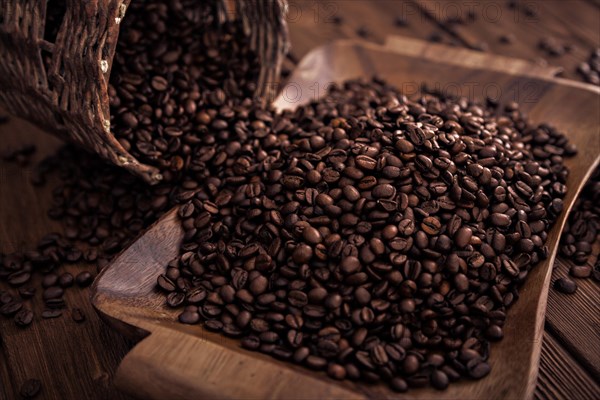 Roasted coffee beans close-up on a wooden surface