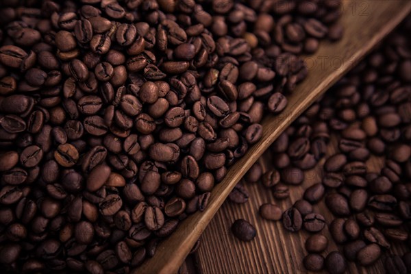 Roasted coffee beans close-up on a wooden surface