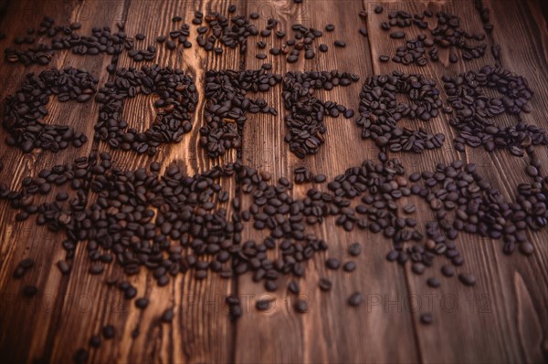 Roasted coffee beans close-up on a wooden surface