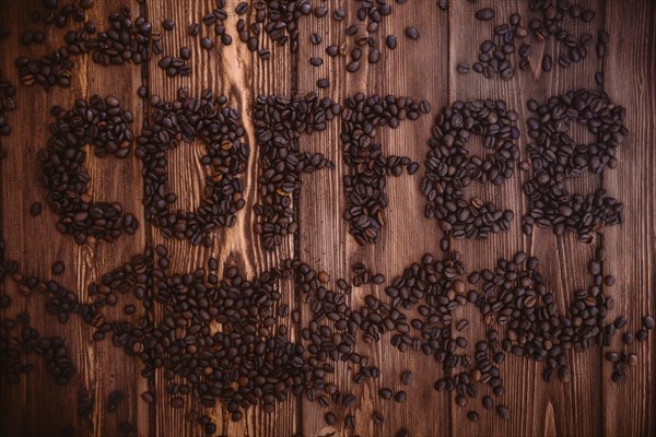 Roasted coffee beans close-up on a wooden surface