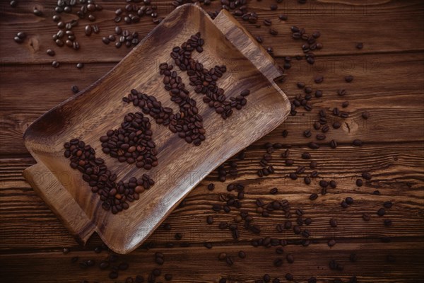 Roasted coffee beans close-up on a wooden surface